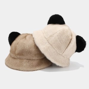 Detail showing plush bucket hats in cream and light brown with cute black 3D ears