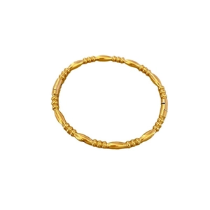 Polished gold bamboo style stainless steel bangle with minimalist minimalist aesthetic