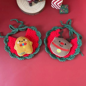 Detail of handmade knit Christmas pet bibs with gingerbread and reindeer designs
