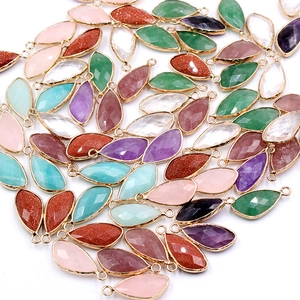 Faceted teardrop crystal pendants in various colors with gold-plated metal borders