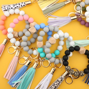 Silicone bead keychain bracelets with wooden hexagons and faux leather tassels in various colors