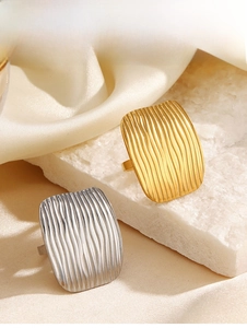 Detail of 18K gold plated and silver rectangular rings with vertical wave texture design