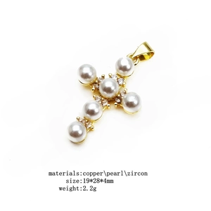 Detailed view of titanium steel cross pendant with white pearls and zircon inlay