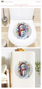Detailed view of round Christmas snowman stickers applied to a toilet lid and cabinet
