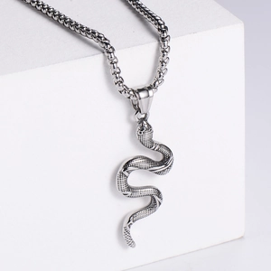Macro detail of silver stainless steel snake pendant with textured scales and box chain