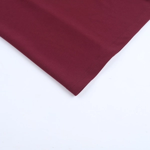 Detail view of the elegant wine red evening dress showing premium stitching and fabric hem