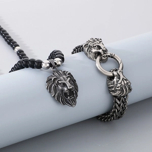 Close-up of vintage stainless steel lion head pendant necklace and bracelet set