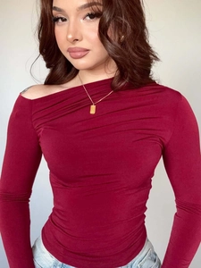 Detail of the pleated off-shoulder neckline on a wine red slim fit long sleeve top