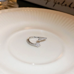 Close-up of silver star open ring with sparkling cubic zirconia on a white plate