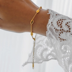Elegant 18K gold-plated marquise chain bracelet for women on a white lace sleeve