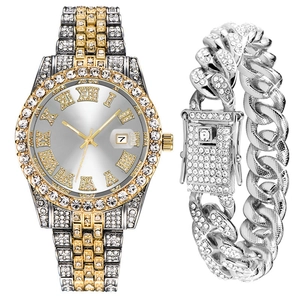Detail shot of iced-out Cuban link bracelet and gold-tone iced bezel watch set