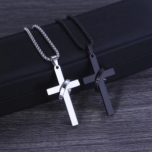 Mens stainless steel cross and ring necklaces in silver and black on display
