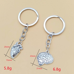 Anatomical heart and brain alloy keychains with dimensions and metallic vintage texture