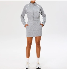 Close-up of light gray knitted sports jacket with white piping details and zipper
