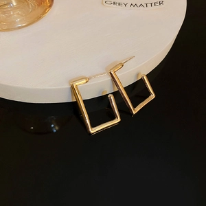 Detail showing S925 hallmark on the gold rectangular hoop earrings for women