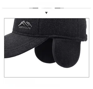 Macro detail of men's winter wool cap featuring mountain embroidery and ear protection