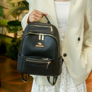 Minimalist black leather backpack with gold zippers and front pocket for women