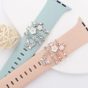 Detail of butterfly and floral charm studs for silicone Apple Watch bands with rhinestones