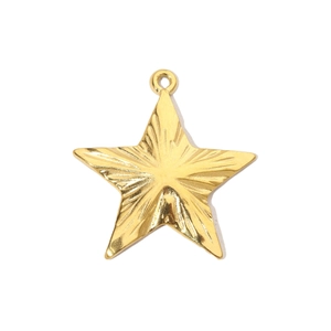 Macro view of gold-colored star pendant with radial texture and circular connector