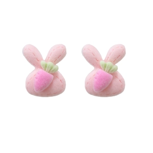 Pair of cute pink plush rabbit stud earrings with carrot detail on white background