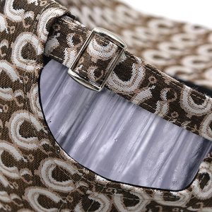 Detail of adjustable metal buckle and jacquard leopard pattern on the baseball cap