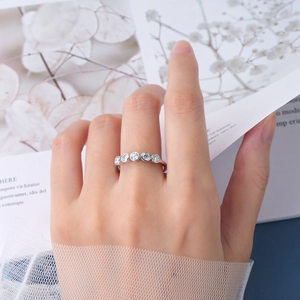 Close-up of model wearing an elegant silver ring with five bezel-set round zircons