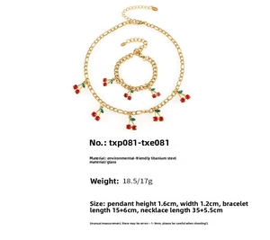 Detail view of red glass cherry necklace and bracelet set with golden titanium steel chains