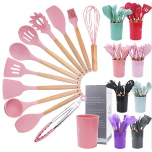 12-piece silicone kitchen utensil set with wooden handles and storage bucket in pink