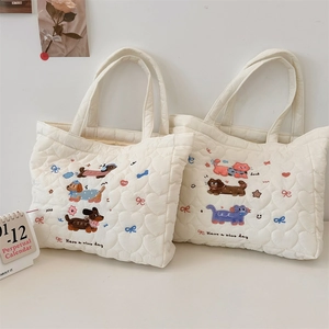 Detailed view of cream quilted cotton handbag with cute animal embroidery and heart texture