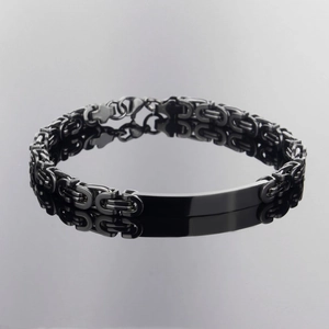 Polished gunmetal stainless steel paperclip chain bracelet with flat ID tag on black mirror