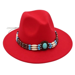Detailed view of red felt fedora hat featuring ethnic band with turquoise beads
