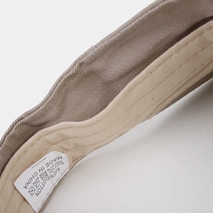 Macro detail of breathable cotton sun hat inner band showing high quality stitching and label