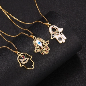 Gold Hamsa Hand and Evil Eye pendant necklaces with colorful zircon on black leather