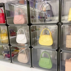 Transparent acrylic storage box displaying colorful macaron jelly bags in a grid