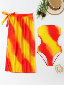 Detail of red and yellow tie-dye monokini with matching sarong and beach accessories