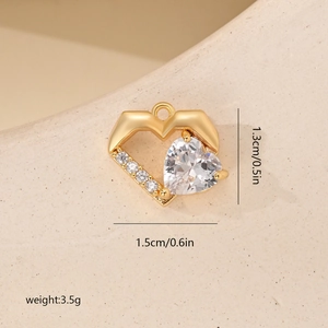 Macro shot of 18K gold heart pendant with cubic zirconia and exact dimensions