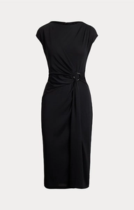 Close-up of black bodycon dress featuring metallic waist buckle and pleated detail