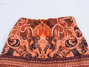 Detail shot of bohemian paisley print on elastic waist of this retro style mini skirt