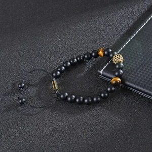 Tiger eye and matte black stone beaded bracelet with gold cubic zirconia pavé ball detail
