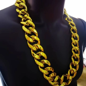 Close-up of a chunky gold CCB Cuban chain necklace displayed on a black neck mannequin