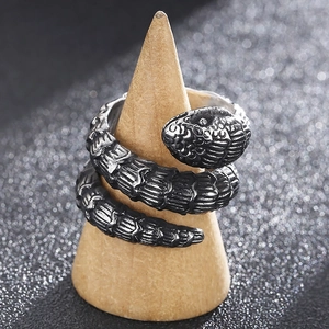 Vintage punk silver snake ring with scale texture on a wooden cone display