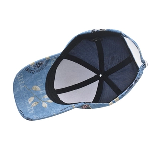 Interior detail of washed denim baseball cap featuring sweatband and Beach King brand label