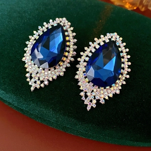 Detail of luxury teardrop blue crystal earrings with sparkling rhinestone settings