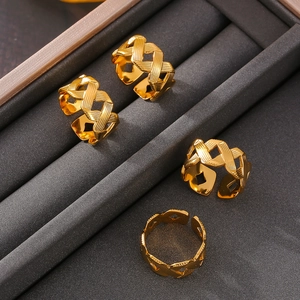Set of four French-style twisted texture rings in 18k gold plated stainless steel