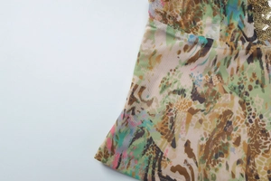 Close-up of leopard print mesh fabric with golden sequins on a slim fit camisole