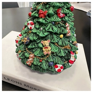 Close-up of resin Christmas tree music box with miniature Santa, bear and gift ornaments