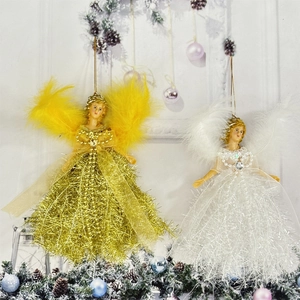 Detailed view of Christmas angel ornaments with feather wings in white and gold colors