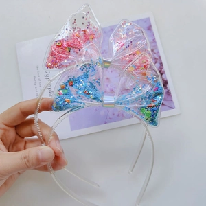Close-up of pink and blue PVC hairbands with colorful liquid sequins and fruit charms