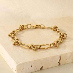 Minimalist 18k gold plated stainless steel Cuban knot chain bracelet on stone surface