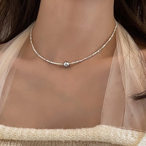 French style silver necklace with a grey pearl on model to show the length and fit